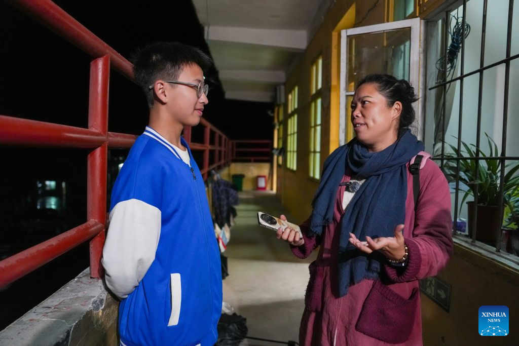 Tan Meizhen (R) talks to a student at Caoyuan school in Caoyuan Village of Longhui County, central China's Hunan Province, Sept. 3, 2026. (Xinhua/Xue Yuge)