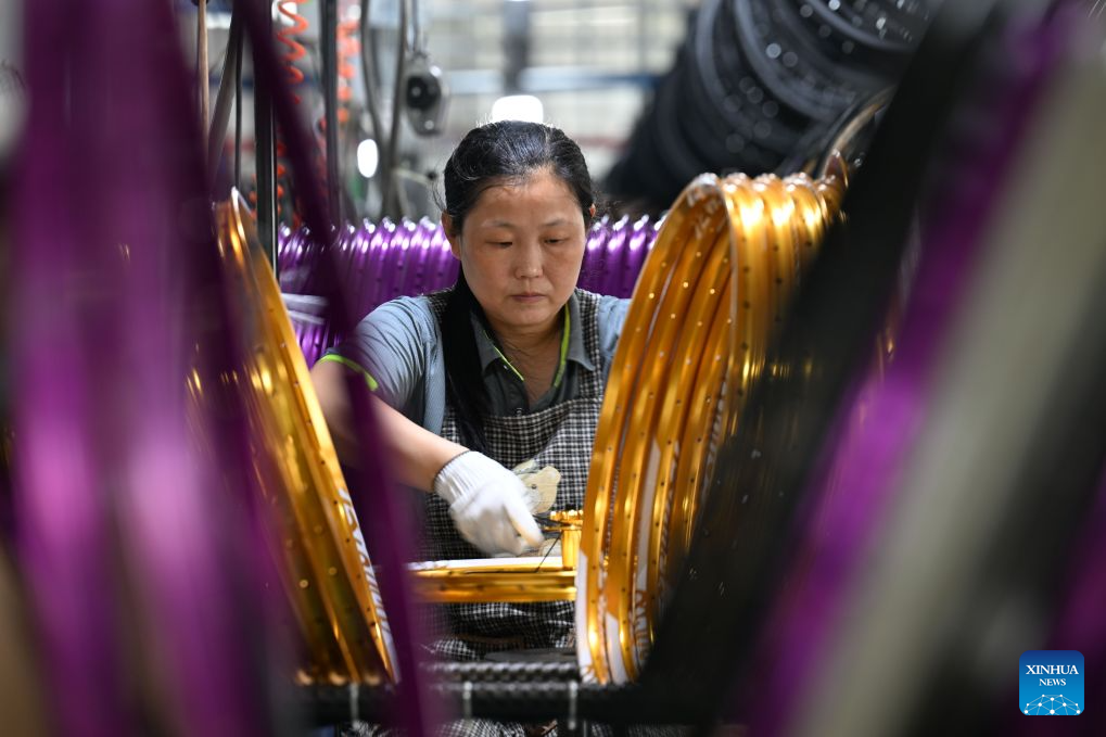 A worker assembles bicycles in a workshop of a bicycle company in Pingxiang County, Xingtai City, north China's Hebei Province, July 22, 2026. Xingtai City is a nationally renowned bicycle manufacturing base, with its products sold worldwide. In recent years, Xingtai has pushed forward the upgrading of the bicycle industry, continuously improved cycling infrastructure, and hosted a wide range of professional cycling races and mass public riding events. By integrating manufacturing and cycling events, the city has fueled accelerated growth of the local bicycle sector. (Photo by Feng Yichao/Xinhua)