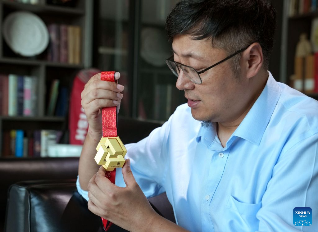 Zhu Xihua, a senior arts and crafts master of China Banknote Printing and Minting, introduces the innovative design of the medals of the 48th WorldSkills Competition in east China's Shanghai, Sept. 8, 2026. Shanghai Mint Co., Ltd. has officially shipped all the medals for the 48th WorldSkills Competition recently, which will be awarded at the competition scheduled to take place in Shanghai from Sept. 22 to 27. (Xinhua/Liu Ying)