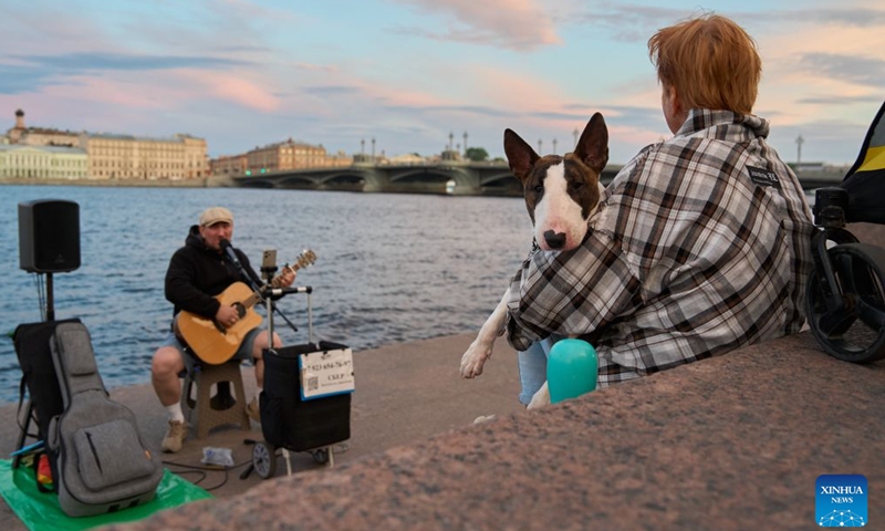 A person enjoys music by the Neva River in St. Petersburg, Russia, June 21, 2026.

St. Petersburg's White Nights is a spectacular summer phenomenon where the city's high northern latitude prevents the sky from getting completely dark. (Photo by Guo Feizhou/Xinhua)