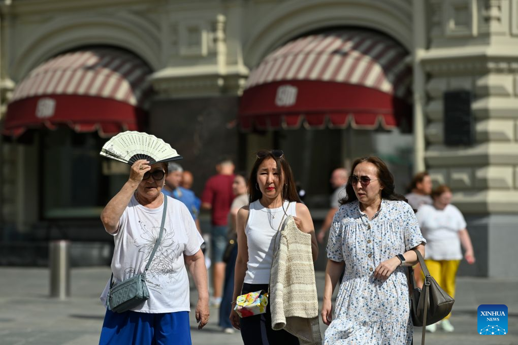 Women walk under the blazing sun in Moscow, Russia, Aug. 6, 2026. (Photo by Alexander Zemlianichenko Jr/Xinhua)