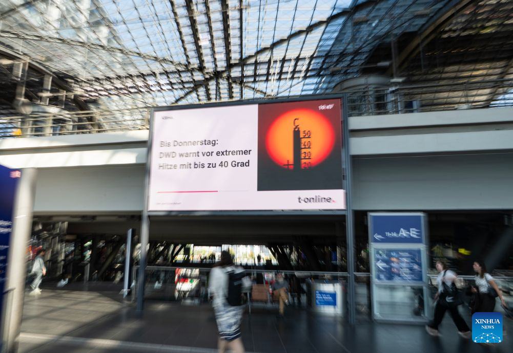 Passengers walk past heat warning display in the main train station in Berlin, capital of Germany, July 30, 2026. Germany recorded an estimated 9,800 heat-related deaths as of July 19, surpassing the annual total for every year since 2016, the Robert Koch Institute (RKI), the country's leading public health authority, said Thursday. (Xinhua/Zhang Haofu)