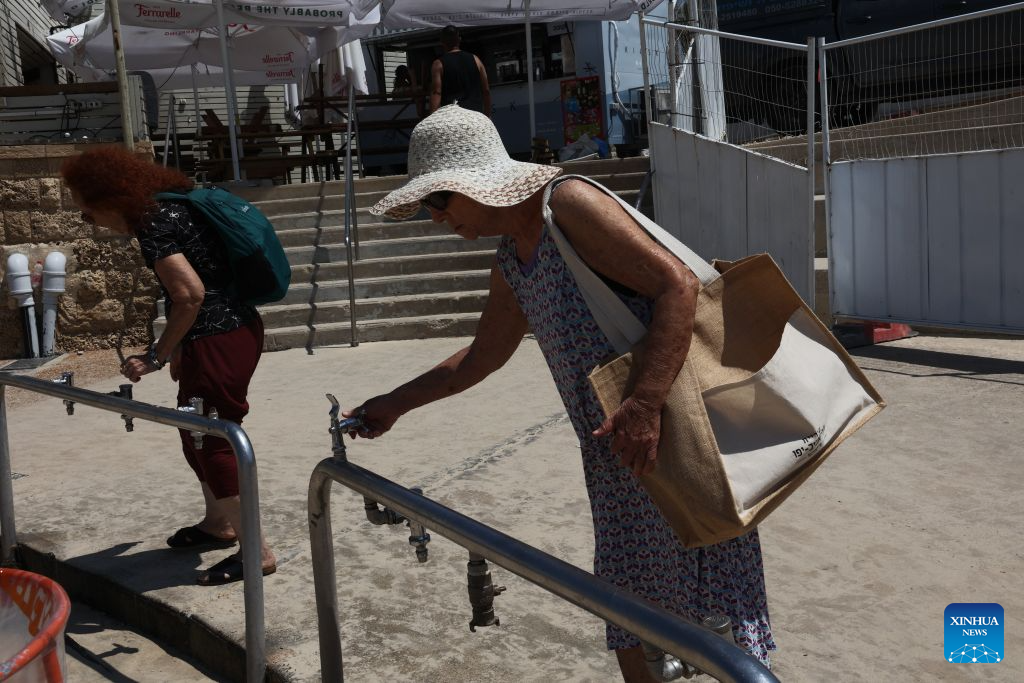 People try to use shower facilities at a beach in Tel Aviv, Israel, Sept. 1, 2026. Most beach showers here have been turned off due to water supply restrictions. Five of Israel's six desalination plants along the Mediterranean coast were shut down again on Tuesday, disrupting drinking water supplies and agricultural irrigation, according to government statements and local media reports. In Tel Aviv, authorities restricted water use for irrigation and beach showers, urging residents to conserve water. (Photo by Gil Cohen Magen/Xinhua)