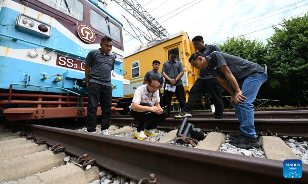 Trainees from Malaysia's East Coast Rail Link (ECRL) project learn practical railway operation under the guidance of a Chinese teacher (2nd L) at the outdoor railway comprehensive training base of Liuzhou Railway Vocational Technical College in Liuzhou, south China's Guangxi Zhuang Autonomous Region, Sept. 15, 2026. Since their operation, the Jakarta-Bandung High-Speed Railway in Indonesia and the China-Laos Railway have played an indispensable role in regional connectivity and mobility under the Belt and Road Initiative. Malaysia's East Coast Rail Link carries high expectations for regional connectivity and integration. This milestone infrastructure project will link key cities and hubs, intertwining with existing railway networks along the corridor. ASEAN countries are seeing a growing demand for professionals proficient in high-speed rail and supporting industries. Leveraging its solid expertise in railway education and Guangxi's unique geographical advantages, Liuzhou Railway Vocational Technical College has forged in-depth cooperative ties with ASEAN countries and established a China-ASEAN rail talent training base. Aligned with the Belt and Road Initiative and Guangxi's marine development strategy, the base cultivates skilled railway professionals and facilitates the global application of China's advanced high-speed rail technologies. Beyond professional technical training, the college also provides international students from ASEAN countries with Chinese language and traditional culture courses, enabling them to gain in-depth insights into Chinese culture. Over the past five years, the college has trained more than 1,200 ASEAN students. (Xinhua/Sun Huanjie)