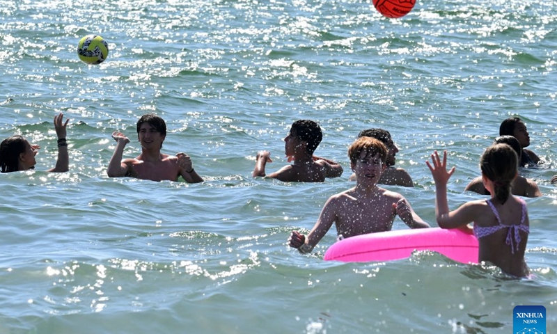 People cool off in the sea in Ladispoli, Italy, June 21, 2026. (Photo by Alberto Lingria/Xinhua)