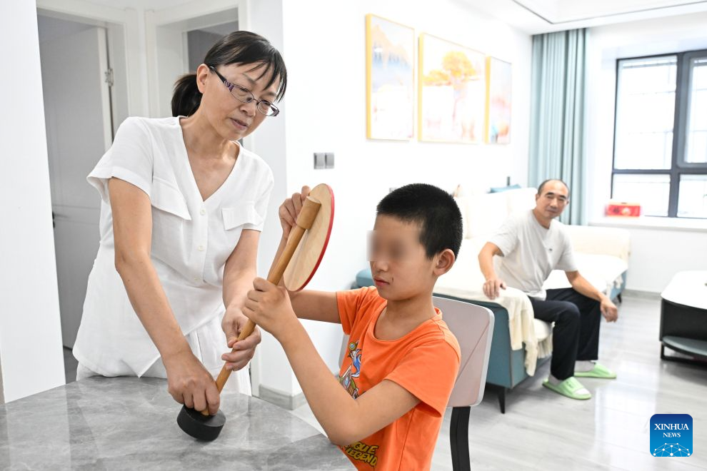 Hu Xuemei, a teacher of Jinhu Special Education School, teaches a student about traffic rules in Jinhu County of Huai'an, east China's Jiangsu Province, Sept. 8, 2026.(Xinhua/Ji Chunpeng)