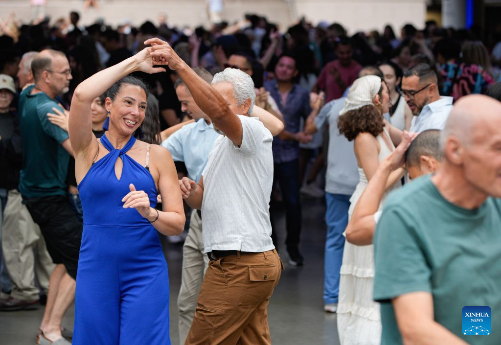 People participate in the Sunday Afternoon Salsa and Bachata event at Robson Square in Vancouver, British Columbia, Canada, on Aug. 30, 2026. Hundreds of people of different ages took part in the annual Sunday Afternoon Salsa and Bachata event here on Sunday. The outdoor event brought together dance enthusiasts and beginners to enjoy Latin-style music and dancing. (Photo by Liang Sen/Xinhua)