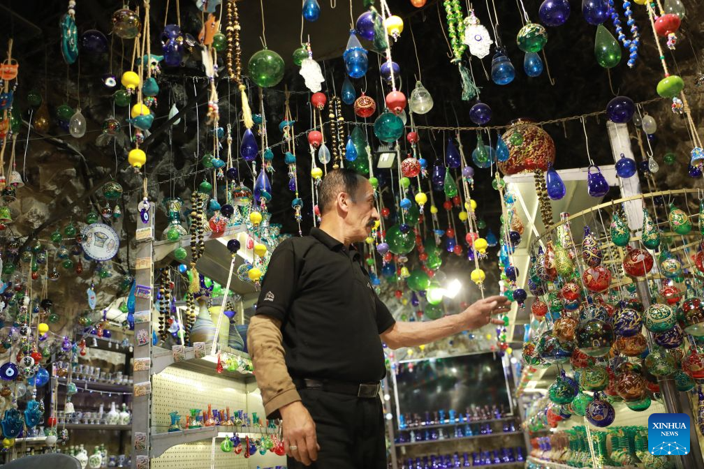 Palestinian Yaqub Al-Natsheh works at his glass factory in the West Bank city of Hebron, on Aug. 23, 2026. The city of Hebron is well known for its skillful glass blowers and designers. Glass factories making hand-blown glass products have a long history in the city. (Photo by Mamoun Wazwaz/Xinhua)