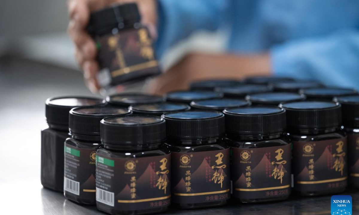A worker pastes labels for honey products at a workshop of a black honey company in northeast China's Heilongjiang Province, July 30, 2026.
Yue Yun, a villager in Shuangsheng Village of Raohe County in northeast China's Heilongjiang Province, has been doing the business of black honeybees for 33 years.
To expand the market of honey produced here, Raohe County in recent years has introduced leading enterprises, which set up cooperatives here and also offer technique training for honeybee farmers, to ensure the quality of honey products.
By far, at the national nature reserve of northeast black honeybees, about 431 honeybee farms have been established and more than 1,300 related workers have been involved. (Photo by Zhang Chunlei/Xinhua)