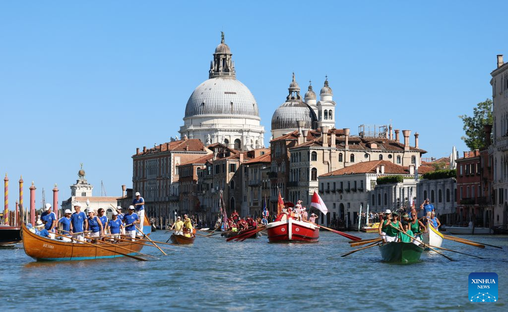 People take part in the Regata Storica boat race in Venice, Italy, Sept. 6, 2026. The Regata Storica is a historic annual boat parade and rowing race on the Grand Canal in Venice. (Xinhua/Wang Kaiyan)