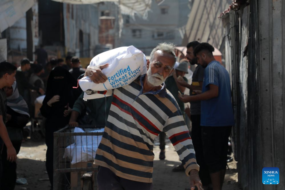 A Palestinian man receives his food ration through the World Food Programme from one of its distribution centers in the Al-Tuffah area east of Gaza City, on Sept. 15, 2026. (Photo by Rizek Abdeljawad/Xinhua)