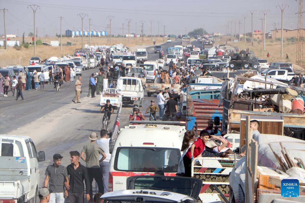 Vehicles carrying displaced Syrian families and their belongings gather before departing for the city of Ras al-Ain and its surrounding villages in Hasakah province, northeastern Syria, Aug. 10, 2026. More than 400 Syrian families returned to the city of Ras al-Ain in northeastern Hasakah province and its surrounding villages on Monday, marking the first organized convoy of displaced residents heading home in that area after nearly seven years of displacement. (Str/Xinhua)