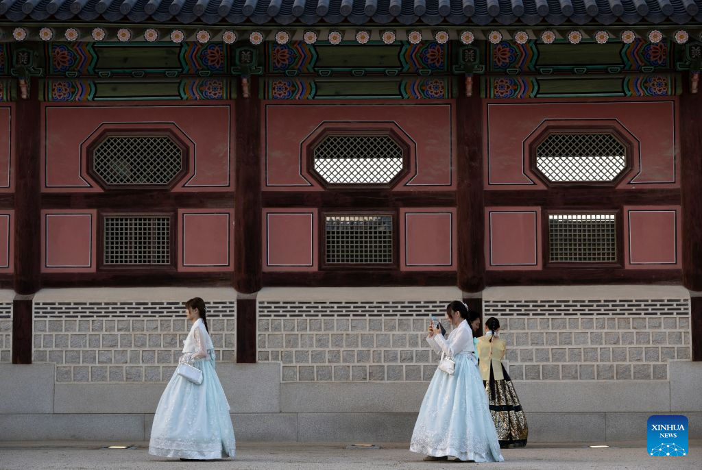 People wearing traditional Korean attire Hanbok take photos as they enjoy their leisure time at the Gyeongbokgung Palace in Seoul, South Korea, Sept. 6, 2026. (Photo by Jun Hyosang/Xinhua)
