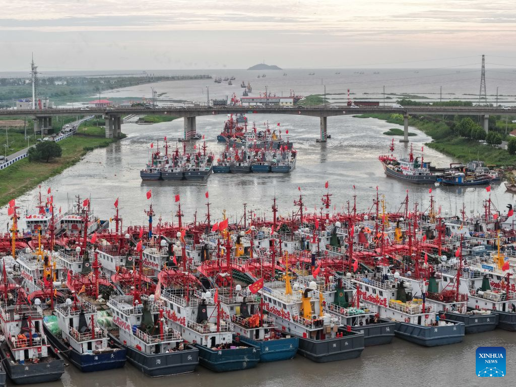 An aerial drone photo taken on Aug. 12, 2026 shows fishing boats preparing to depart for the Yellow Sea after a fishing ban was lifted in Lianyungang City, east China's Jiangsu Province. Special licensed fishing vessels set out to the Yellow Sea as the summer fishing moratorium was partially lifted on Aug. 12, which had been postponed for a week due to impacts of Typhoon Dolphin. (Photo by Si Wei/Xinhua)