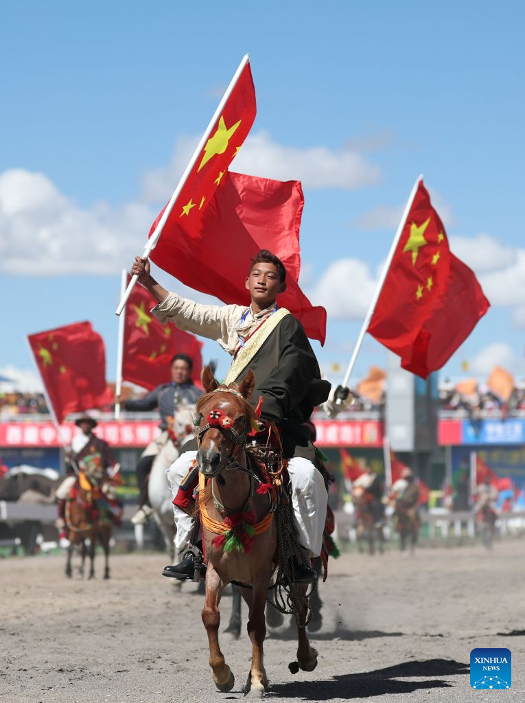 Horse racers parade during the opening ceremony at the Nagqu Horse Racing Festival 2026 at Gesar Racecourse in Nagqu, southwest China's Xizang Autonomous Region, Aug. 10, 2026. Featuring traditional equestrian contests, ethnic sports performances and trade fair, the event kicked off here on Monday, drawing large crowds of locals and visitors. (Xinhua/Zhang Chen)