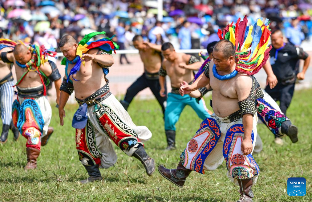 People perform at the opening ceremony of a Nadam fair in Jalaid Banner of Hinggan League, north China's Inner Mongolia Autonomous Region, Aug. 16, 2026. The Nadam fair opened here on Sunday, featuring equestrian performances, songs and dances, instrumental music and traditional folk performances. (Photo by Wang Zheng/Xinhua)