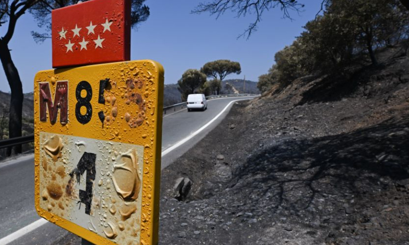 This photo taken on July 29, 2026 shows a damaged road sign after a fire in the Madrid region, Spain. Spanish Prime Minister Pedro Sanchez announced on Thursday the end of the national emergency declared over wildfires in the province of Avila and the Madrid region, as fires in the two areas have largely stabilized, while blazes remain active elsewhere amid a new heatwave and strong winds. (Xinhua/Cheng Min)