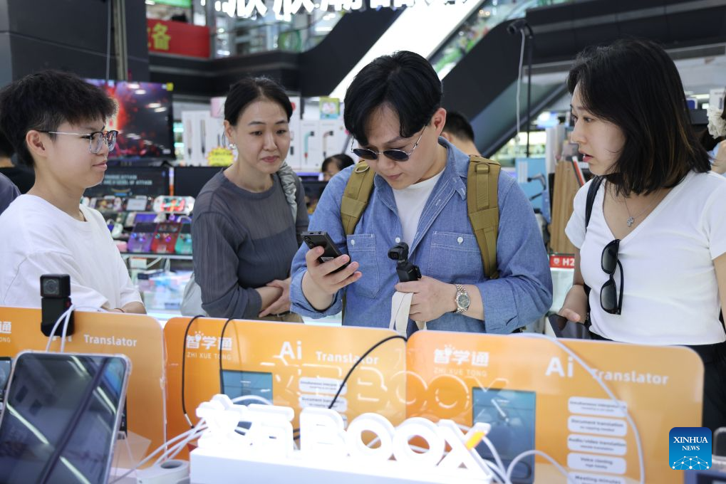 This photo taken on June 24, 2026 shows tourists from South Korea experiencing AI translator at Huaqiangbei of Shenzhen, south China's Guangdong Province. With the deep application of the achievements of emerging industries, many inbound foreign tourists choose science and technology tour as the theme of their journey in the Chinese cities.
In Shenzhen, foreign tourists are attracted by AI applications and technology scenarios in daily life, such as AI glasses, smart robots and unmanned delivery service. (Xinhua/Liang Xu)