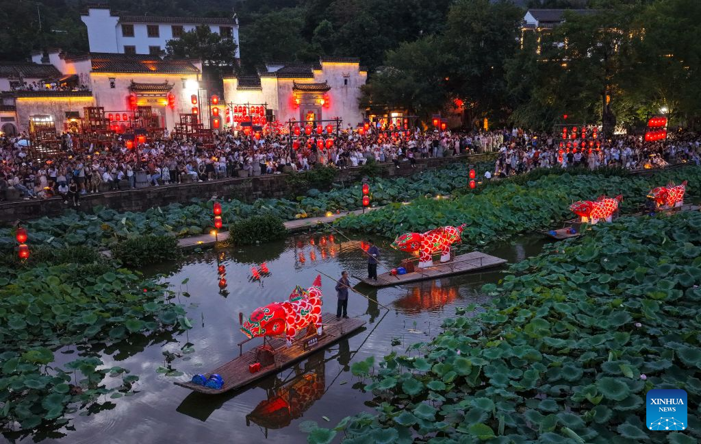 A drone photo shows a fish lantern parade staged in Chengkan Village of Huizhou District in Huangshan City, east China's Anhui Province, Aug. 3, 2026.
Parade processions of the giant fish-shaped lantern meander through the streets in the ancient villages of Huangshan, creating a stunning spectacle at night. Many visitors came here to experience the parades, benefiting local tourism and related industries. (Photo by Shi Yalei/Xinhua)
