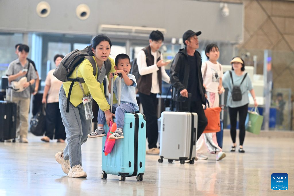Passengers wait to check in at the waiting room of Shijiazhuang Railway Station in Shijiazhuang, north China's Hebei Province, Aug. 31, 2026. The 62-day summer travel rush officially concluded on Monday. (Photo by Chen Qibao/Xinhua)