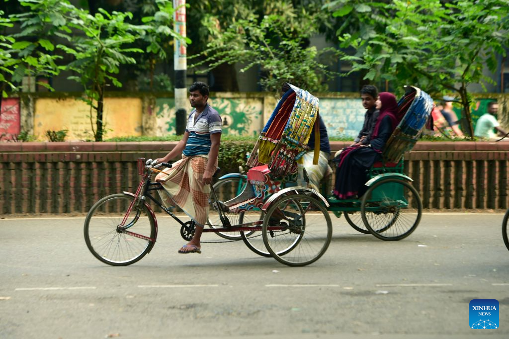 This photo taken on Aug. 22, 2026 shows rickshaws on a street in Dhaka, Bangladesh. In 2023, UNESCO announced the inclusion of Bangladesh's iconic rickshaws and rickshaw painting in Dhaka on the Representative List of the Intangible Cultural Heritage of Humanity. (Photo by Habibur Rahman/Xinhua)