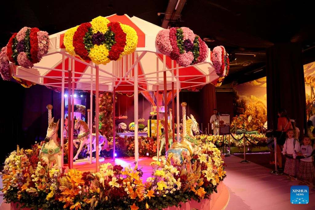 Visitors attend a flower exhibition in Tel Aviv, Israel, Aug. 18, 2026. Around 50 Israeli floral designers spent weeks using millions of flowers to create a vibrant floral wonderland. (Photo by Gil Cohen Magen/Xinhua)
