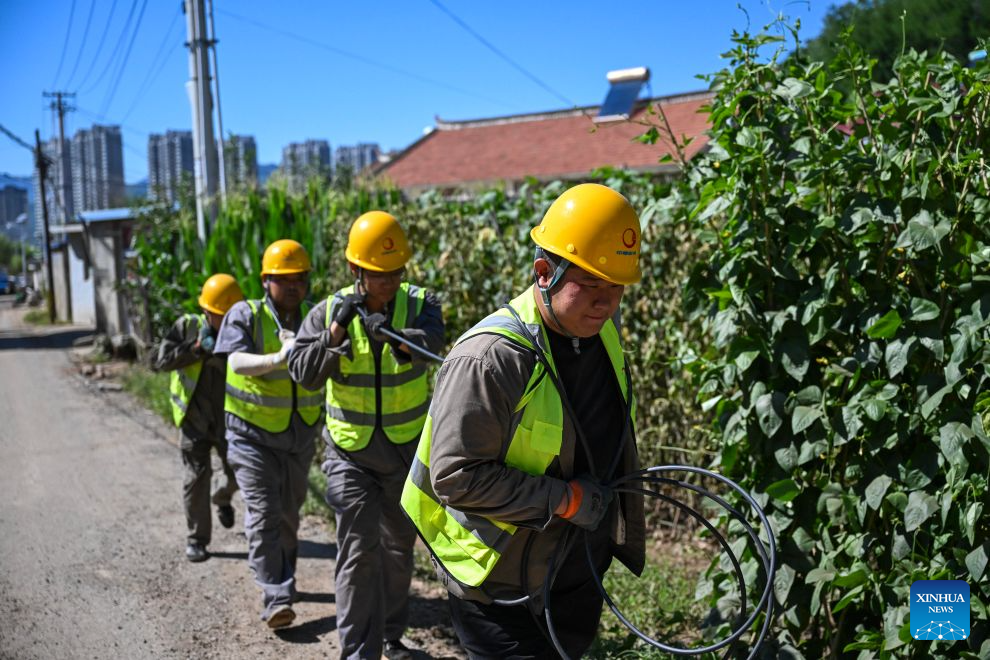 Staff members repair disrupted telecommunication lines in Zhangzhangzi Village, Kuancheng Manchu Autonomous County of Chengde, north China's Hebei Province, July 15, 2026. Recently, heavy rainfall lashed four townships and nine villages in Kuancheng Manchu Autonomous County. Local authorities have launched relief efforts to restore infrastructure and normal life. (Photo by Wang Liqun/Xinhua)