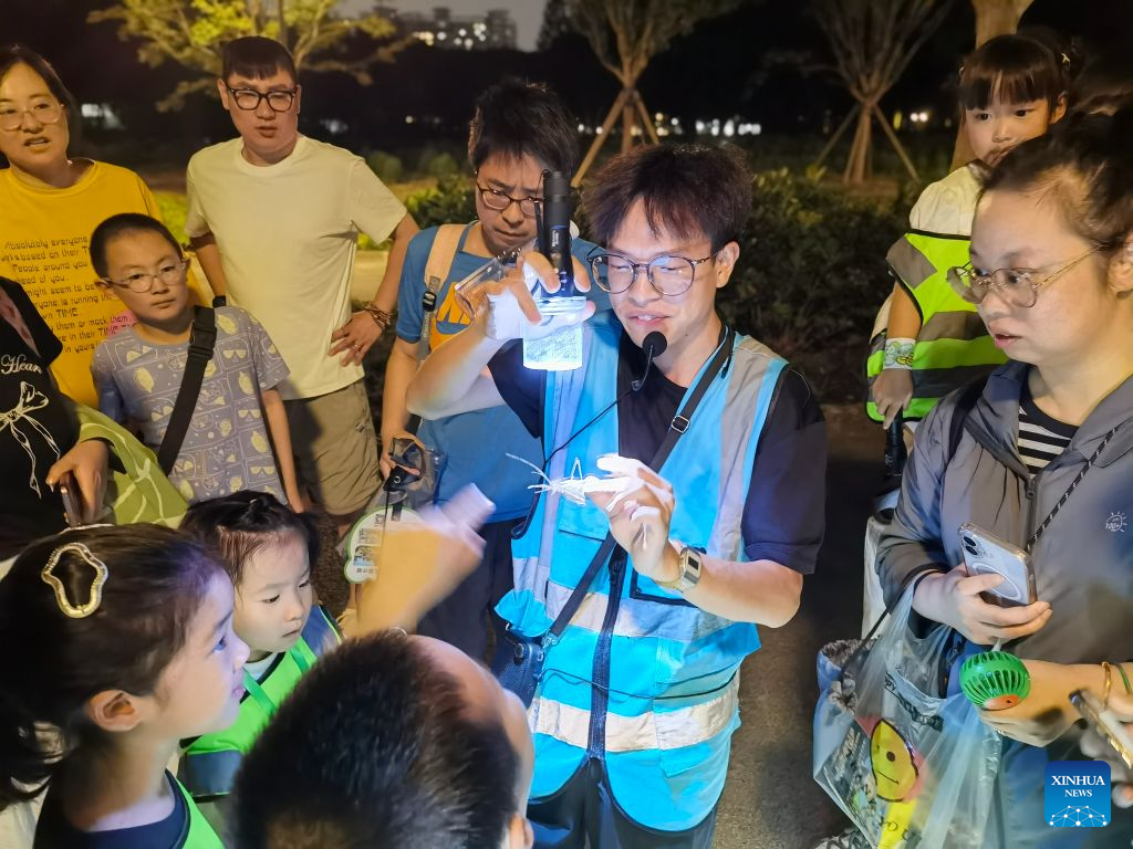 People participate in a nighttime insect science popularization event at Shanghai Century Park in east China's Shanghai, Aug. 1, 2026. (Xinhua/Chen Aiping)