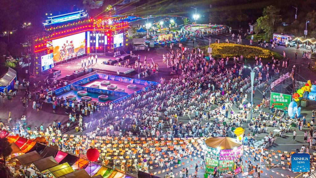 A drone photo taken on Aug. 1, 2026 shows a nighttime market at the Langya Mountain scenic area in Chuzhou, east China's Anhui Province. Located in the southwest of Chuzhou, the Langya Mountain scenic area is home to the renowned Zuiweng Pavilion, which was featured in a celebrated essay by Northern Song Dynasty literary figure Ouyang Xiu. In summer, the scenic area attracts visitors with daytime sightseeing and nighttime markets. (Photo by Ji Chengjun/Xinhua)