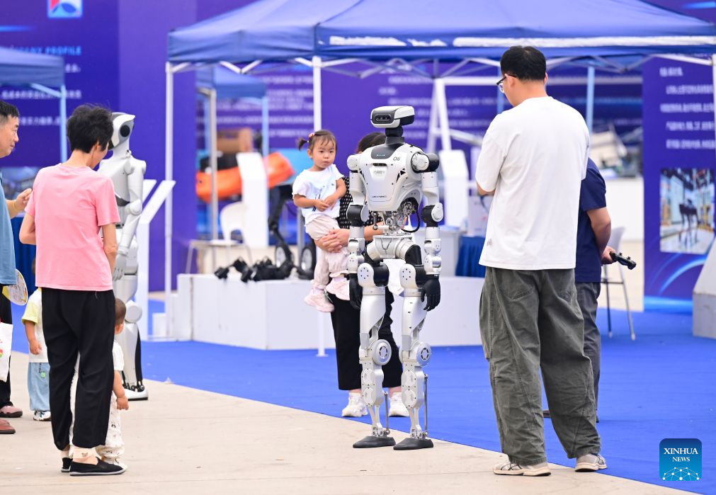This photo taken on Sept. 20, 2026 shows people watching a humanoid robot during the All-Space Unmanned Ecosystem Conference & Equipment Achievement Exhibition at Luogang Park in Hefei, east China's Anhui Province. Various unmanned technologies are displayed during the World Manufacturing Conference. As part of the event, the All-Space Unmanned Ecosystem Conference & Equipment Achievement Exhibition is held in Luogang Park, displaying the latest technologies, products and scenarios solutions in the field of all-space unmanned system. (Xinhua/Zhou Mu)