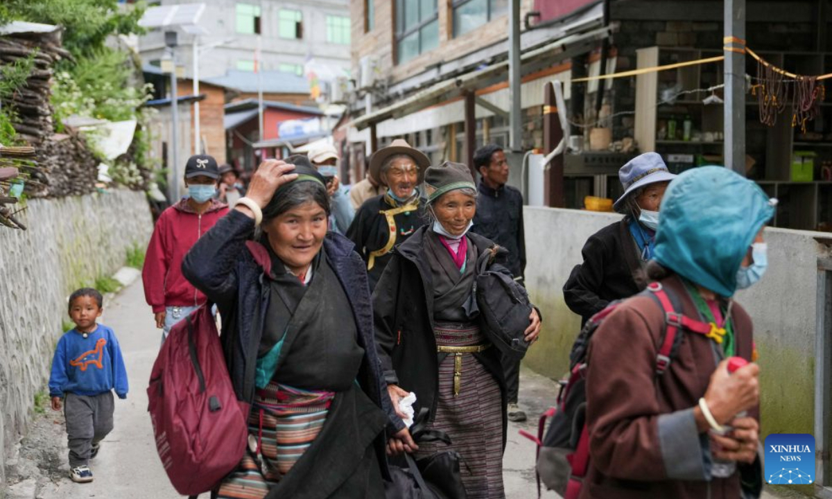 Evacuees from Labi Village enter a hostel in Jifu Village of Gyirong County in Xigaze, southwest China's Xizang Autonomous Region, Aug. 27, 2026. Residents affected by a mudslide in Gyirong County, southwest China's Xizang Autonomous Region, have been resettled, and all stranded tourists have been transferred, local authorities said Thursday. A total of 499 villagers and construction workers have all been properly accommodated. Meanwhile, 555 affected tourists were evacuated and transferred under the coordination of cultural and tourism authorities. No tourists remain stranded. Civil aviation authorities have also joined the rescue efforts. As of 3 p.m. Thursday, civil aviation services had transported 324 rescue personnel and delivered 24 tonnes of rescue equipment, daily necessities and medical supplies to the disaster-hit area, providing support for emergency response and the relocation of affected residents. The mudslide struck Gyirong Port in Gyirong County, Xizang, on Wednesday morning. As of 8 a.m. on Thursday, three people had been killed, 558 others remained missing, while two local villagers had been rescued. (Xinhua/Jigme Dorje)