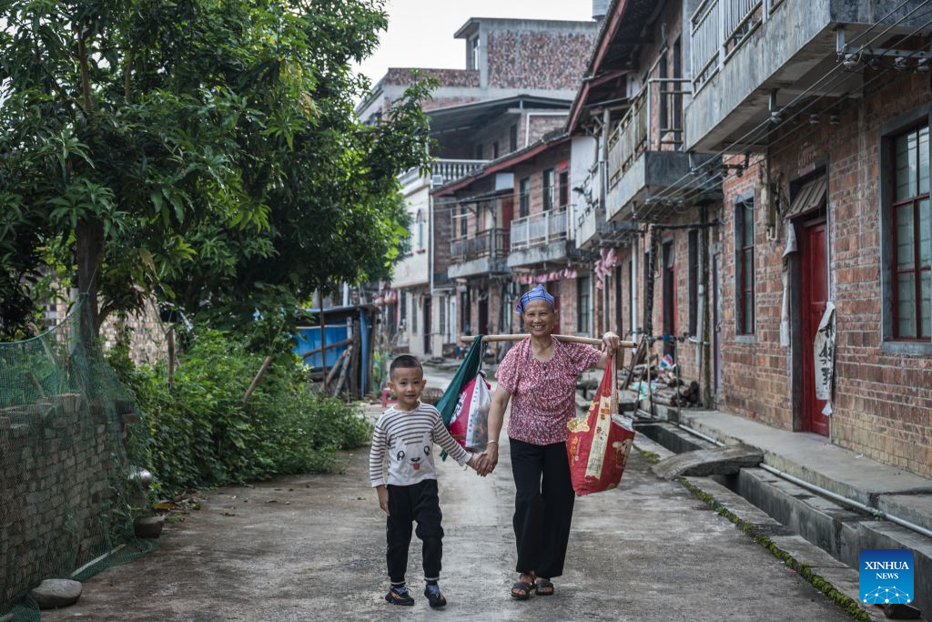 A child and his grandmother walk to a ferry crossing in Banda Village, Bo'ai Town of Funing County, Wenshan Zhuang and Miao Autonomous Prefecture, southwest China's Yunnan Province, Aug. 30, 2026. Bo'ai Town in Funing County is surrounded by mountains, with rough roads and many rivers. For many years, students from nearby villages had a difficult trip to school. They either traveled on mountain roads by vehicle or crossed rivers on privately run boats to arrive at schools in the town.

Since 2021, local authorities have worked together to provide free ferry services for students. Seven water school buses now run regularly at 12 ferry crossings in the town, taking students to and from school at different time according to their school schedules.

Today, 329 students in Bo'ai Town use the ferry services. Since 2021, the service has carried students on more than 147,000 trips. (Xinhua/Wang Guansen)