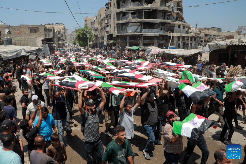 Palestinians attend the mass funeral of 112 victims in Gaza City on Aug. 4, 2026.
The funeral came after the remains of the victims were recently recovered from beneath the rubble of houses destroyed in an Israeli airstrike in November 2023. (Photo by Rizek Abdeljawad/Xinhua)