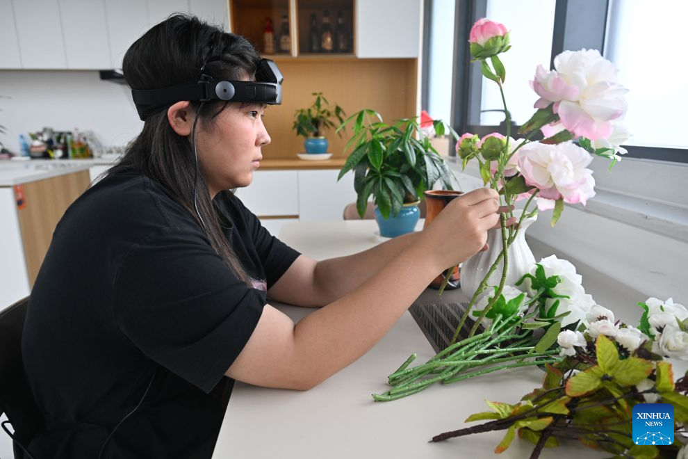 A technician collects data for housework scenario at a robot data collection center of Chinese e-commerce giant JD.com in Suqian, east China's Jiangsu Province, Aug. 12, 2026. In operation since October 2025, JD.com's robot data collection center is a provincial-level embodied intelligent robot data collection center in east China's Jiangsu Province. The facility enhances the data collection scenarios in terms of physical fidelity, generalization ability, and interaction quality. It upgrades the data collection environment to a real physical scene, transforming the data collection center from a static sample library into a training ground for embodied intelligent robots. (Xinhua/Ji Chunpeng)