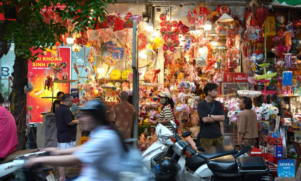 People shop for lanterns and other decorations for the Mid-Autumn Festival at the Old Quarter in Hanoi, Vietnam, Sept. 22, 2026. A festive atmosphere is growing here as the Mid-Autumn Festival approaches. (Xinhua/Liu Ying)
