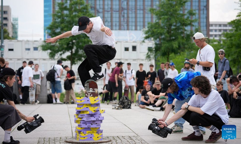 A man performs a trick with his skateboard to celebrate the annual Go Skateboarding Day in Warsaw, Poland, June 21, 2026. (Photo by Jaap Arriens/Xinhua)