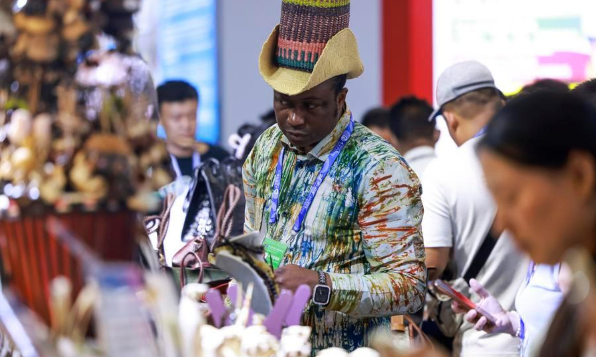 A staff member arranges exhibits at the booth of Nigeria during the 9th China-Eurasia Expo in Urumqi, capital of northwest China's Xinjiang Uygur Autonomous Region, June 25, 2026. (Xinhua/Wang Fei)