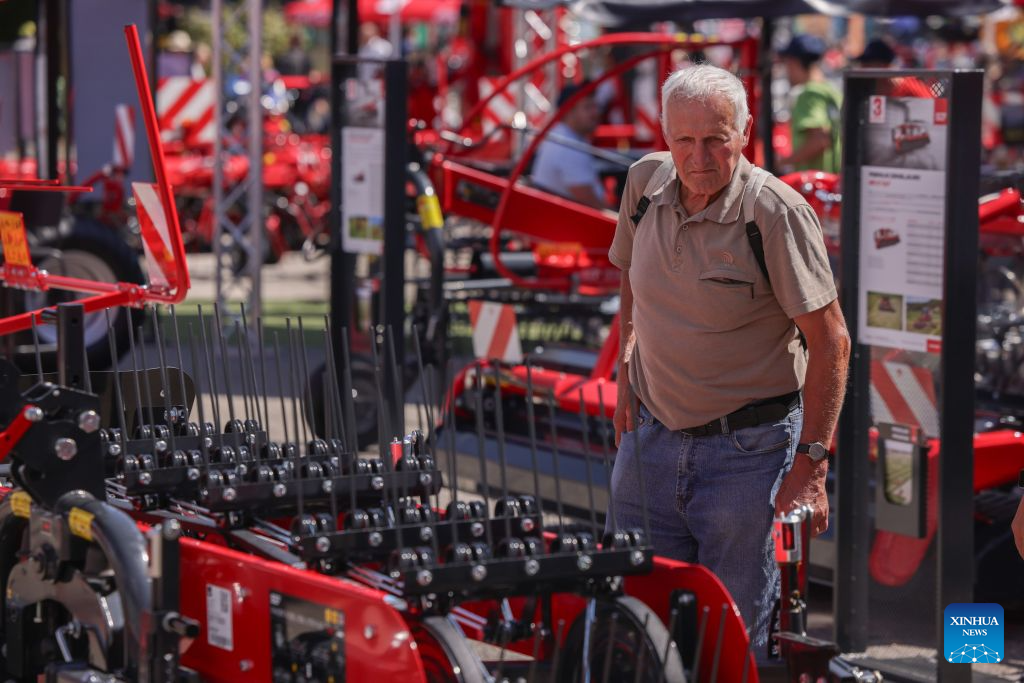 A visitor observes agricultural machinery on display during the 64th International Fair of Agriculture and Food (AGRA) in Gornja Radgona, northeast Slovenia, Aug. 24, 2026. (Photo by Zeljko Stevanic/Xinhua)