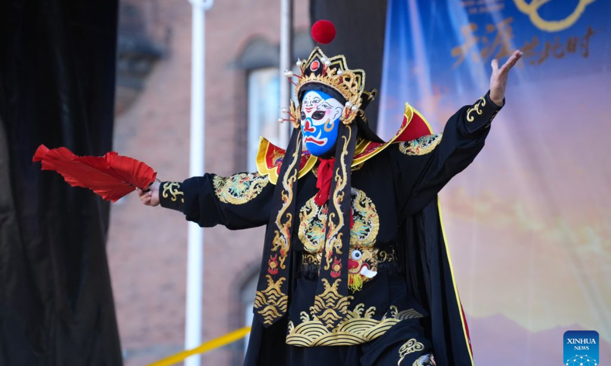 A performer presents face-changing during the first Copenhagen China Festival at Copenhagen City Hall Square in Copenhagen, Denmark, Sept. 27, 2026. Drums, lion dances, opera movements and the aroma of Chinese food filled Copenhagen's City Hall Square on Sunday as the first Copenhagen China Festival was held in celebration of the Mid-Autumn Festival.(Photo by Liu Zhichao/Xinhua)