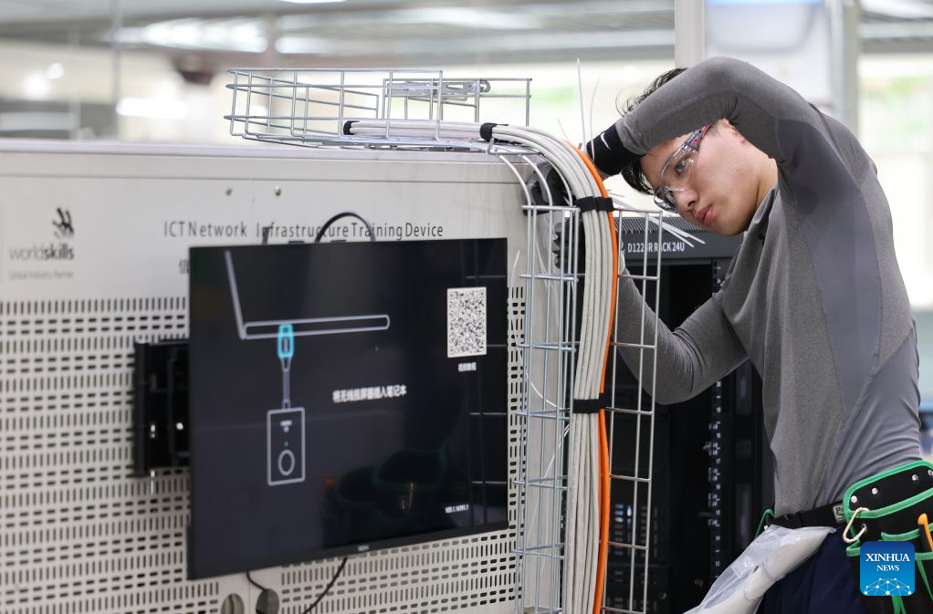 Liu Yuxuan prepares for the 48th WorldSkills Competition at a training base of Tianjin Electronic Information Technician College in Tianjin, north China, Sept. 2, 2026. Liu Yuxuan, a student from Tianjin Electronic Information Technician College, has been preparing extensively for the information and communication technology network infrastructure skill competition at the 48th WorldSkills Competition in Shanghai.
Liu enrolled in the college in 2022 at the age of 16, where he first took up information network cabling and began his skills competition journey. Starting as a reserve team member, he stood out through the college's tiered training system and his own relentless efforts, claiming gold at the third National Skills Competition in 2025 and earning a spot in the national WorldSkills training squad.
The information and communication technology network infrastructure skill competition will run for 22 hours across modules including fiber cabling, copper cabling, smart network applications, fiber speed testing and troubleshooting. It tests both your body and mind, Liu said.
With the competition just around the corner, Liu keeps working on every aspect of his skills, ready to showcase the spirit of China's young skilled talents on the global stage. (Xinhua/Li Ran)