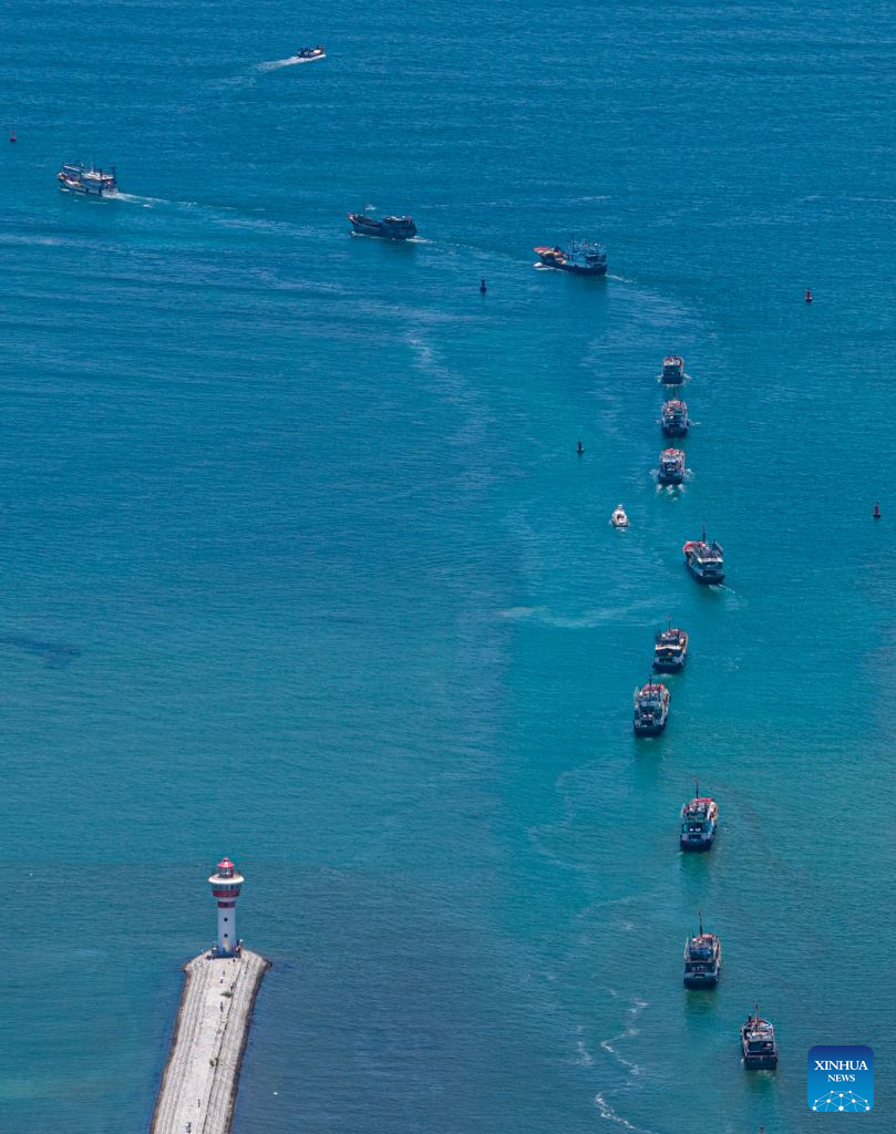 An aerial drone photo taken on Aug. 16, 2026 shows fishing boats departing for fishing from Tanmen port in Qionghai, south China's Hainan Province. The fishing season of the South China Sea kicked off at noon on Sunday after this summer's three-and-a-half-month fishing ban. (Xinhua/Pu Xiaoxu)