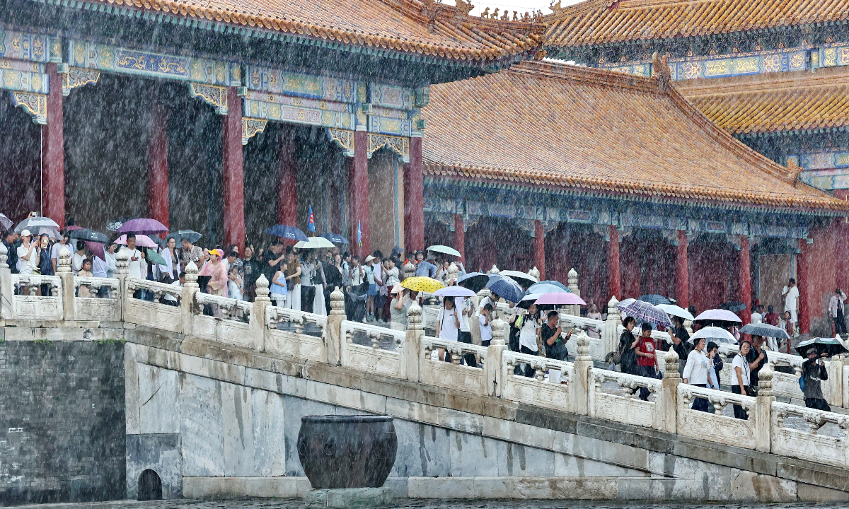 Visitors toured the Palace Museum during heavy rain after a sudden downpour in Beijing on August 2, 2026. Photo: VCG
