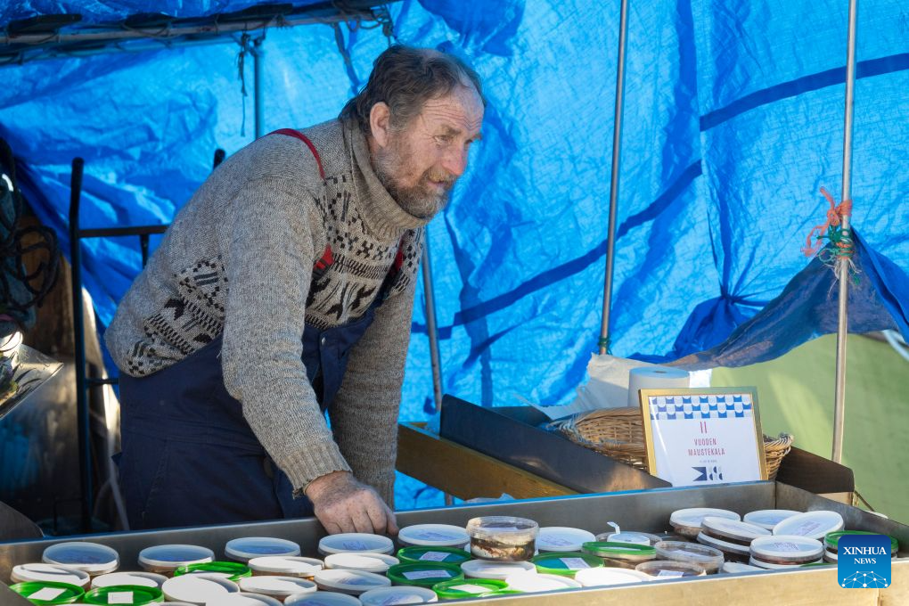 A vendor waits for customers during the Helsinki Baltic Herring Market at Market Square in Helsinki, capital of Finland, Oct. 7, 2026. The Helsinki Baltic Herring Market is held in Helsinki, the capital of Finland. In 2026, it runs from October 4 to 10. Dating back to 1743, it is one of Finland's oldest public events, aimed at supporting fishermen's livelihoods and promoting local seafood, particularly Baltic herring. (Photo by Matti Matikainen/Xinhua)