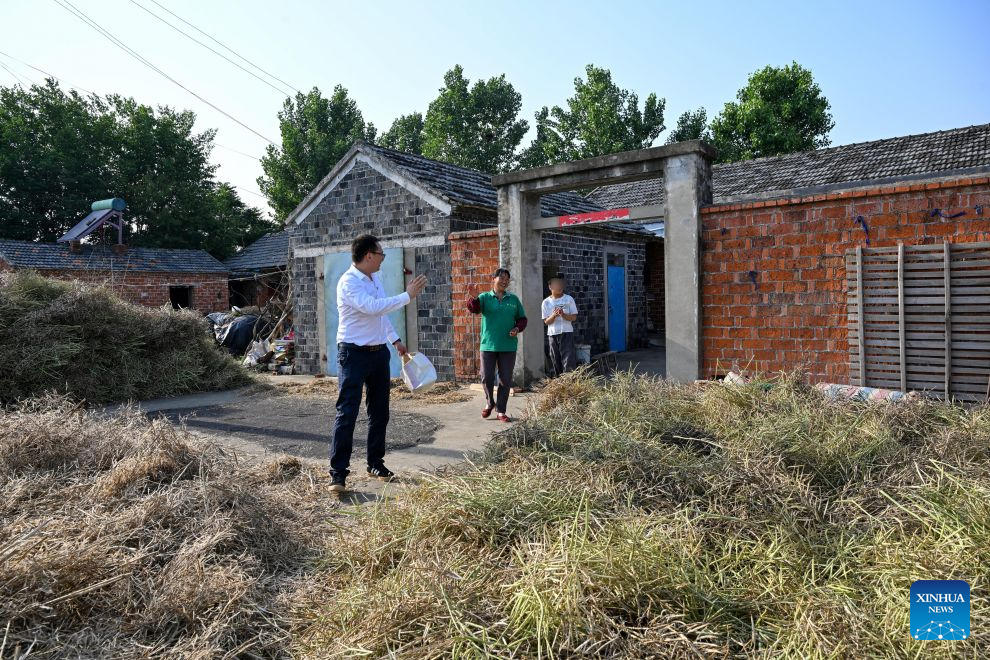 Du Shuai (1st L), a teacher of Jinhu Special Education School, waves goodbye to a student in Jinhu County of Huai'an, east China's Jiangsu Province, May 28, 2026. (Photo by Liang Debin/Xinhua)