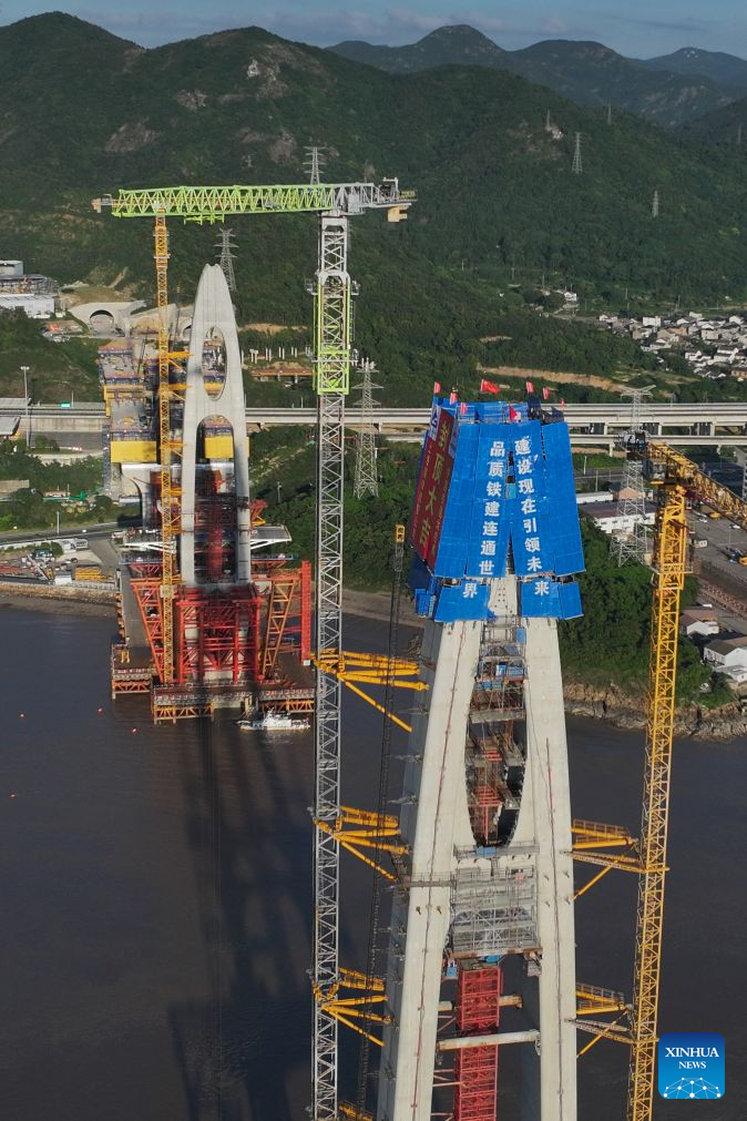 An aerial drone photo taken on Sept. 12, 2026 shows the construction site of the No. 20 main tower of Fuchimen road-rail bridge along Ningbo-Zhoushan Railway in Zhoushan, east China's Zhejiang Province. The main tower, constructed by the China Railway Major Bridge Engineering Group Co., Ltd., was successfully topped out on Sunday, marking the completion of the construction of all six main towers of the three cross-sea bridges of the Ningbo-Zhoushan Railway.

The main line of the Ningbo-Zhoushan Railway is 76.4 kilometers long, starting from Ningbo East Railway Station in the west and ending at Zhoushan Island in the east, with a designed speed of 250 kilometers per hour. (Xinhua/Huang Zongzhi)
