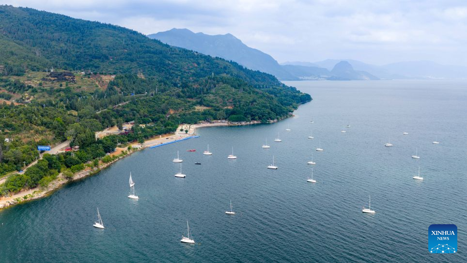 An aerial drone photo taken on Sept. 14, 2026 shows the scenery of a scenic area on the west bank of Fuxian Lake in Yuxi City, southwest China's Yunnan Province. In recent years, local authorities have stepped up efforts to protect ecological environment of Fuxian Lake and developed more lakeside activities, combining the natural scenery with local fishing culture to create more consumption experiences. (Xinhua/Hu Chao)
