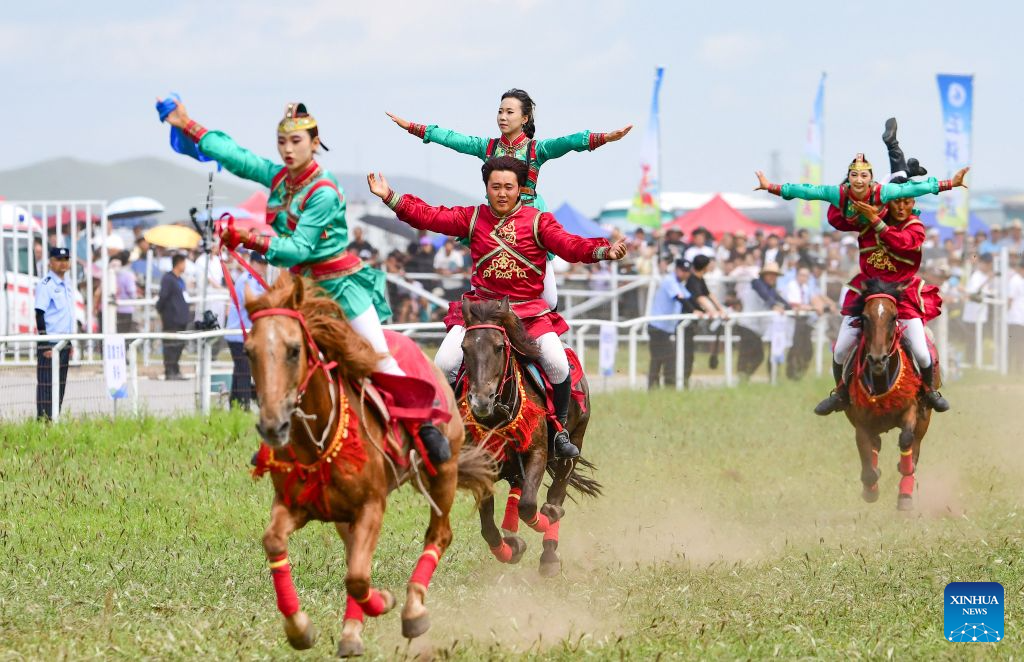 People perform equestrian skills at the opening ceremony of a Nadam fair in Jalaid Banner of Hinggan League, north China's Inner Mongolia Autonomous Region, Aug. 16, 2026. The Nadam fair opened here on Sunday, featuring equestrian performances, songs and dances, instrumental music and traditional folk performances. (Photo by Wang Zheng/Xinhua)