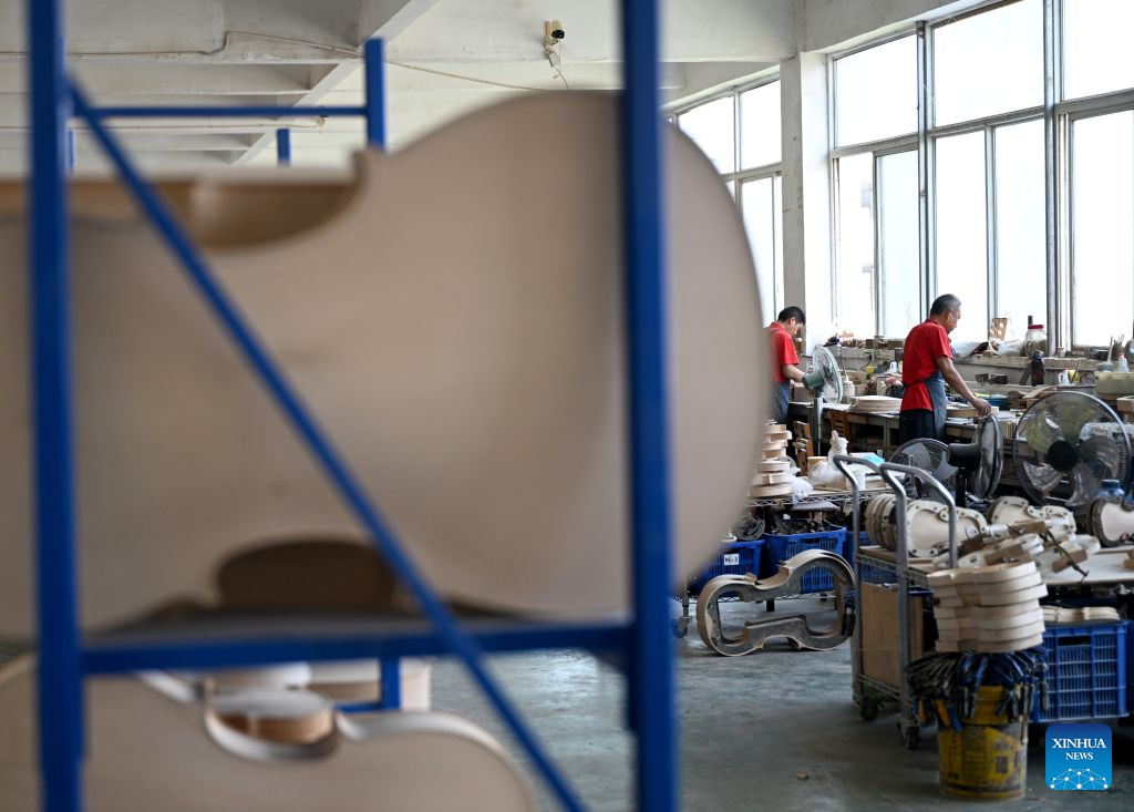 Staff members work at a string instrument manufacturer in Queshan County of Zhumadian City, central China's Henan Province, Sept. 12, 2026. The violin-making industry of Queshan County thrived in recent years as skilled luthiers returned home to start their own businesses. With an annual output of about 400,000 violins, Queshan produces more than 80 percent of made-in-China medium- and high-end violins, violas, cellos, bass and violin accessories. Many violin-related products from Queshan are made for exports to international markets including Italy, the United States, France and Germany. (Xinhua/Hao Yuan)