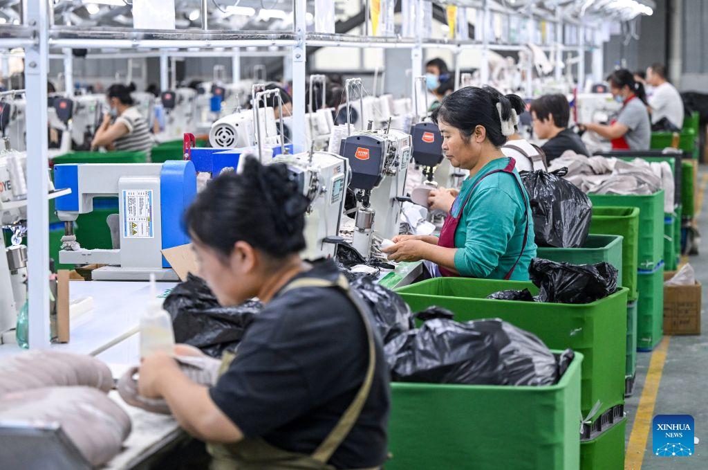 People work at a workshop of a shoe factory in Changxingji Township of Dongming County in Heze, east China's Shandong Province, Sept. 17, 2026. Many neighboring villagers are employed here. The Yellow River, dubbed the Mother River of China, has long nourished the land in Heze, east China's Shandong Province, but recurring floods once posed a persistent threat to residents living on its floodplain. To protect local residents from flooding, a large-scale relocation and reconstruction project was launched in 2017 and completed in 2020.
Some 600,000 residents from the floodplain moved into newly built communities with improved housing and access to kindergartens, community clinics, elderly care centers and public spaces. In recent years, local authorities have also developed agriculture, rural processing and tourism-related industries to create more income opportunities for residents. (Xinhua/Chen Yehua)