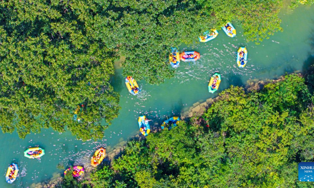 A drone photo taken on Aug. 2, 2026 shows tourists enjoying drifting at the Langya Mountain scenic area in Chuzhou, east China's Anhui Province. Located in the southwest of Chuzhou, the Langya Mountain scenic area is home to the renowned Zuiweng Pavilion, which was featured in a celebrated essay by Northern Song Dynasty literary figure Ouyang Xiu. In summer, the scenic area attracts visitors with daytime sightseeing and nighttime markets. (Photo by Ji Chengjun/Xinhua)